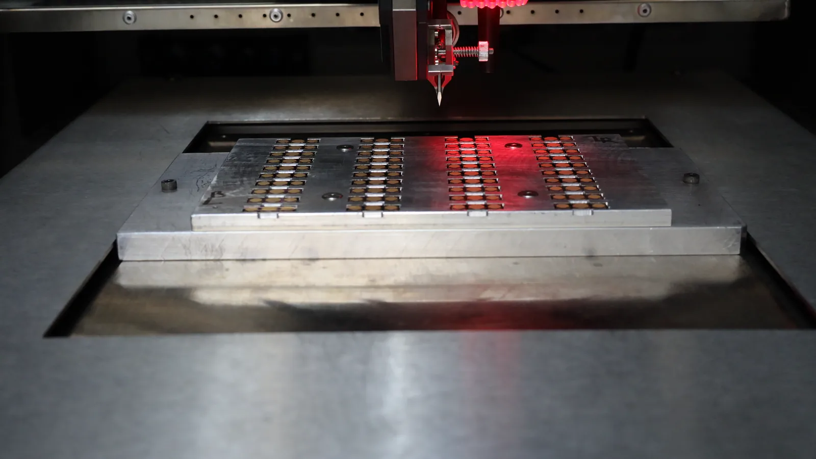 Laser beam line across a panel on the stage — dicing and singulation