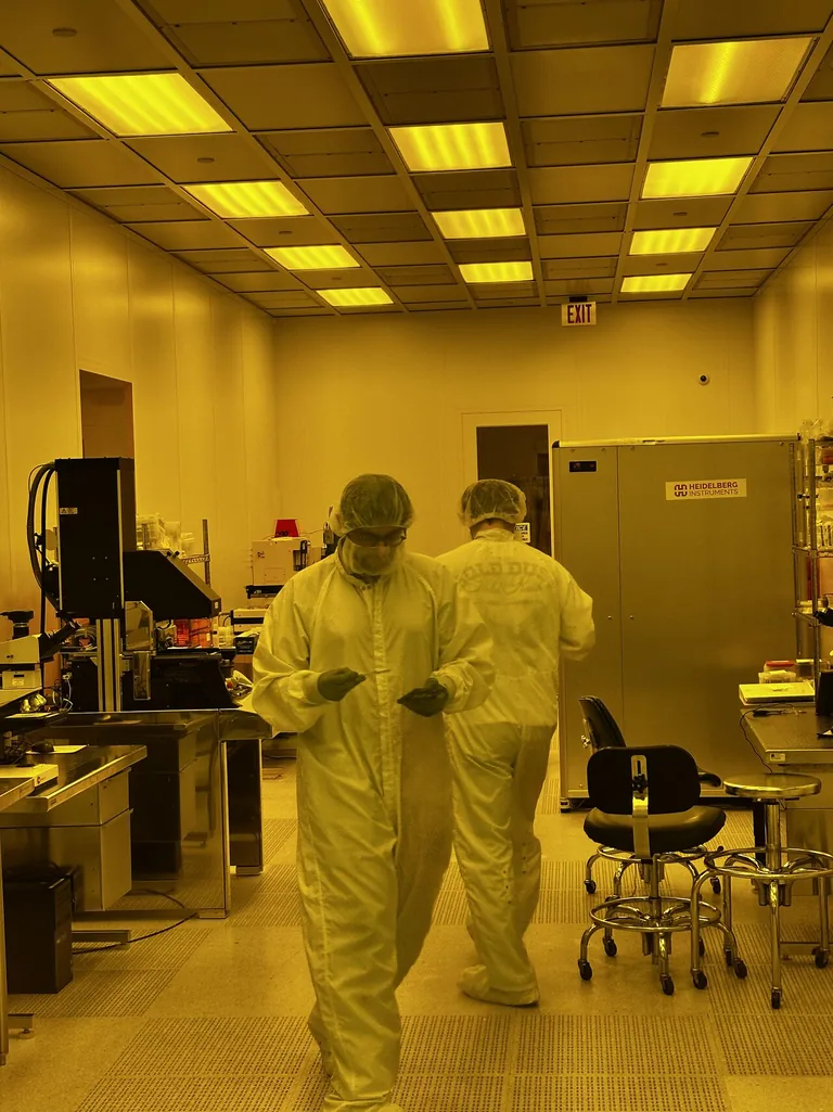 Technicians in cleanroom garments inside a semiconductor fab — Heisler Semiconductor