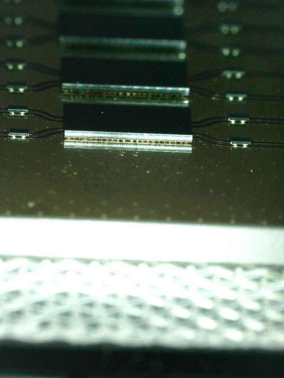 Edge view of stacked, bonded dies